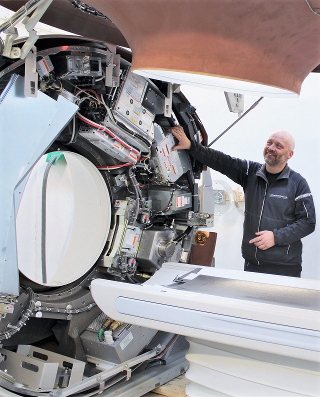 Refurbished medical equipment - CT scanner with a technician