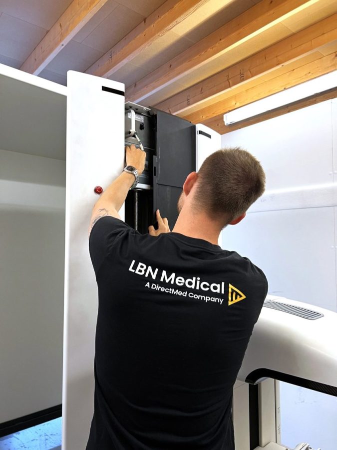 Techinican working on a mammography machine. LBN Medical.